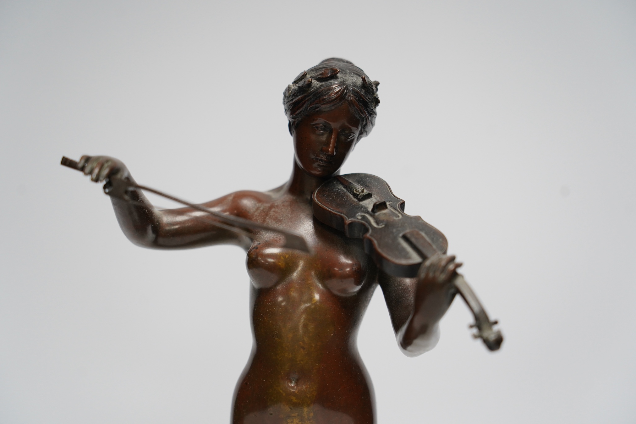 After Eugene Delaplanche (1836 - 1891), a brown patinated figure, La Musique, signed M. Matthias, on serpentine marble base, 31cm